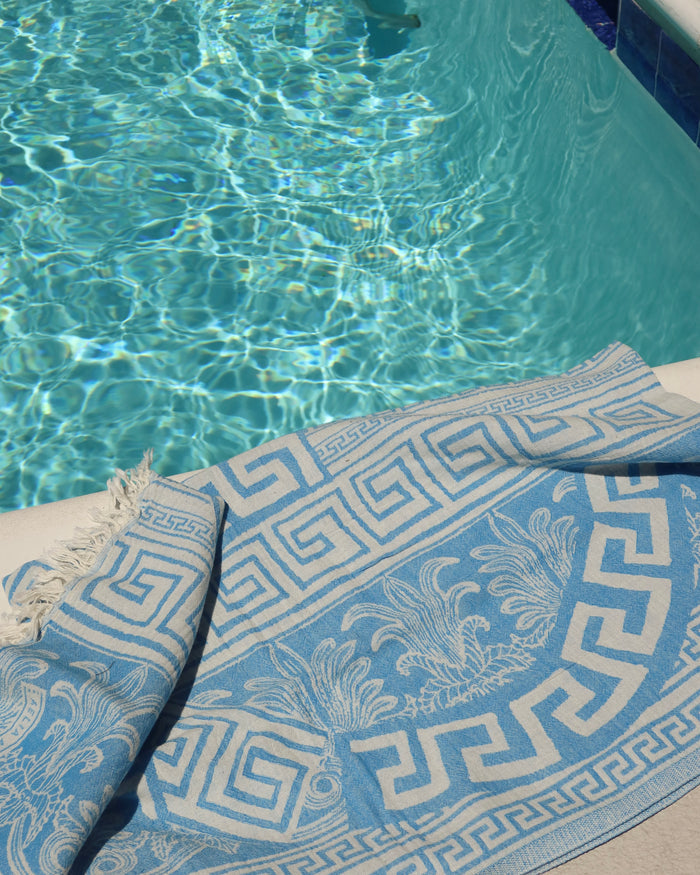 Blue and cream Greek key meander print cotton towel next to a pool, pestemal towel pareo made in Greece