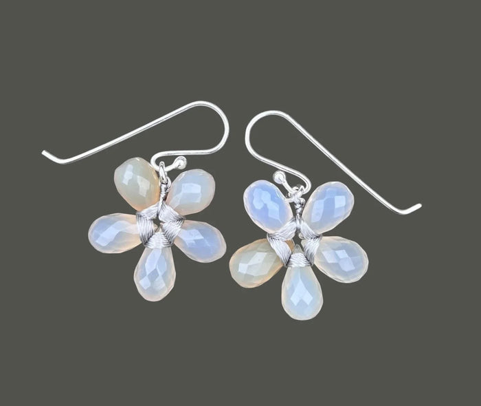 The ANN LIGHTFOOT Faceted Grey Onyx Glower Earrings feature blossom-inspired designs with five translucent, teardrop-shaped grey onyx petals and sterling silver hooks. The image background is plain white.