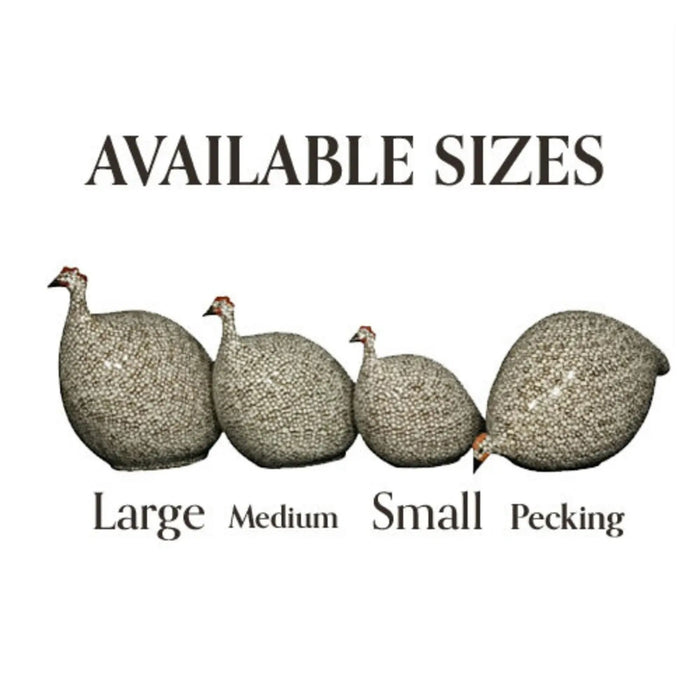 A round, handmade ceramic guinea hen sculpture from LES CERAMIQUES DE LUSSAN—the PECKING CERAMIC FRENCH GUINEA IN BORDEAUX SPOTTED WHITE—stands on a white pedestal against a plain background, showcasing French artistry in pottery and the brand’s iconic spotted pattern.