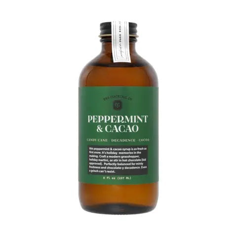 An 8 fl oz brown glass bottle from YES COCKTAIL CO. with a black cap, featuring a green label that reads “PEPPERMINT & CACAO” in white text. The YES COCKTAIL CO. PEPPERMINT & CACAO COCKTAIL SYRUP is an all-natural mixer blending candy cane freshness with decadent cocoa for a festive flavor experience.